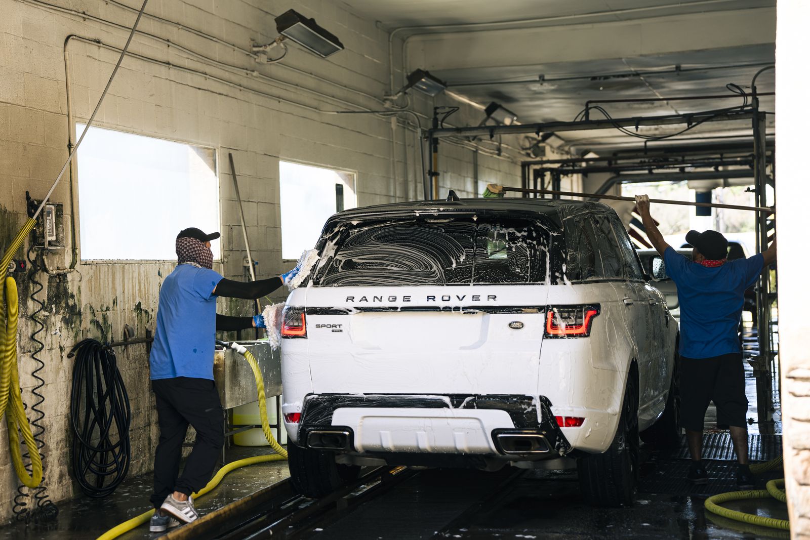 A Range Rover being hand-washed in the wash bay