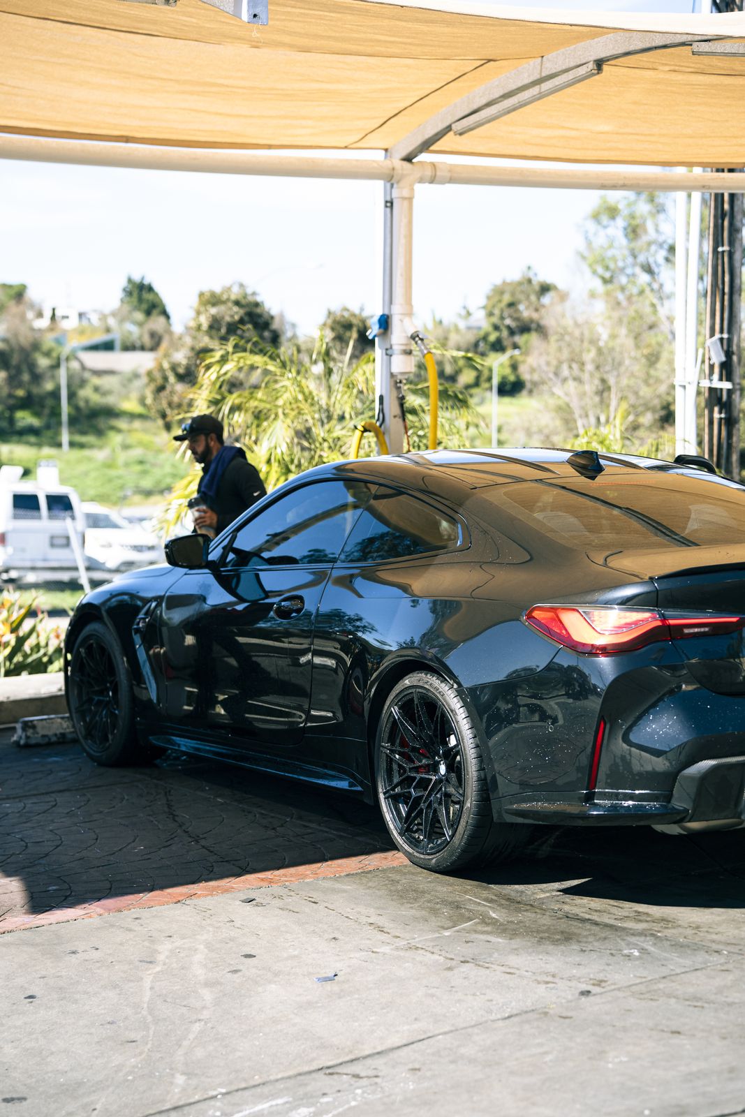A black BMW M under the shade canopy
