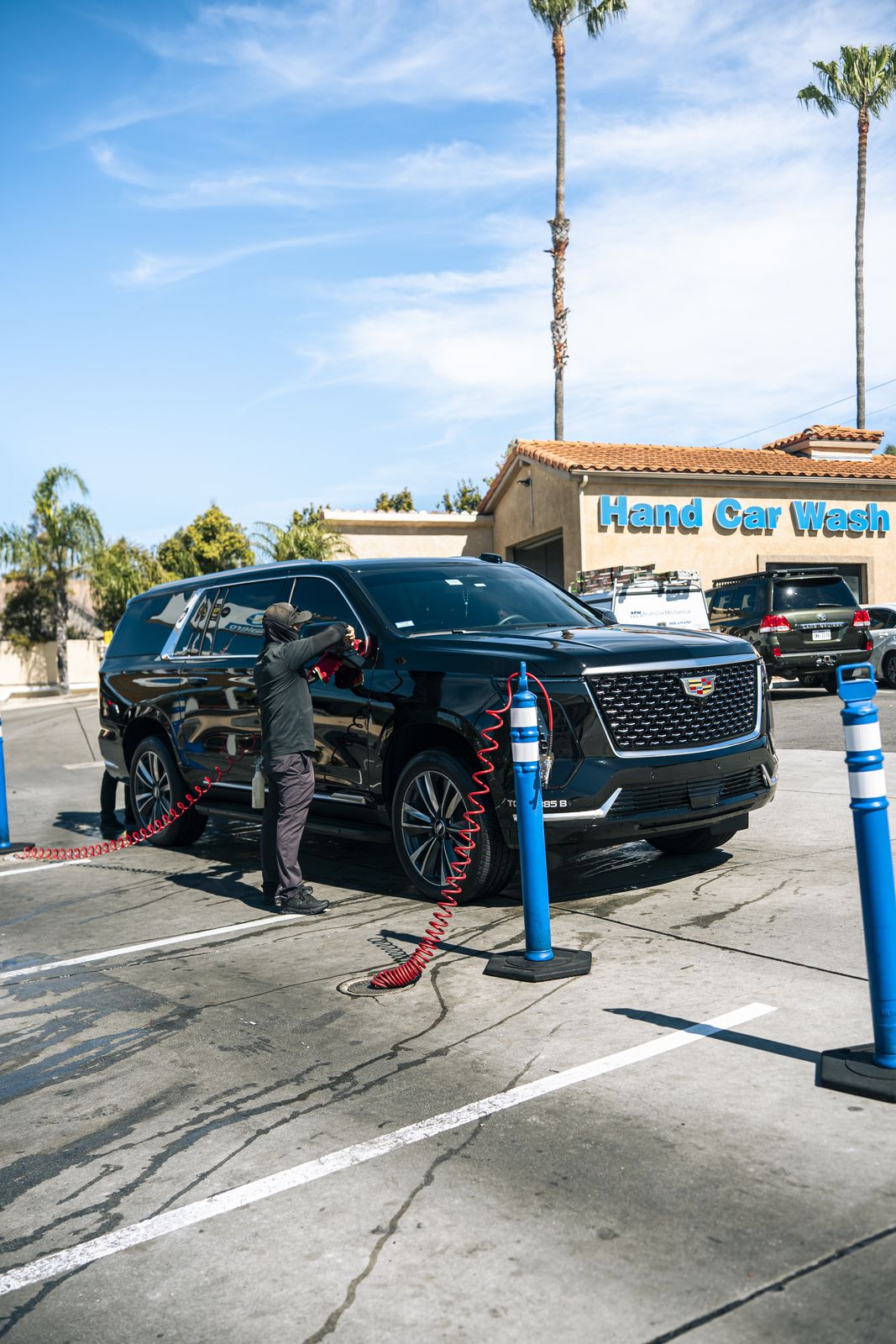 A black Cadillac Escalade in front of the storefront