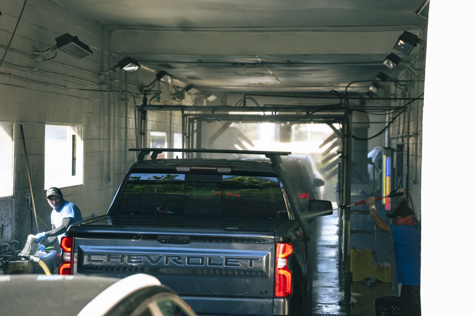 A Chevrolet truck being hand-washed in the wash bay